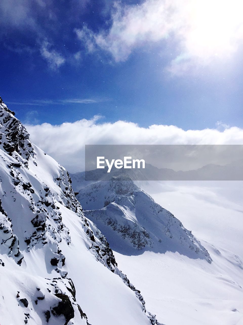 SCENIC VIEW OF MOUNTAINS AGAINST SKY DURING WINTER