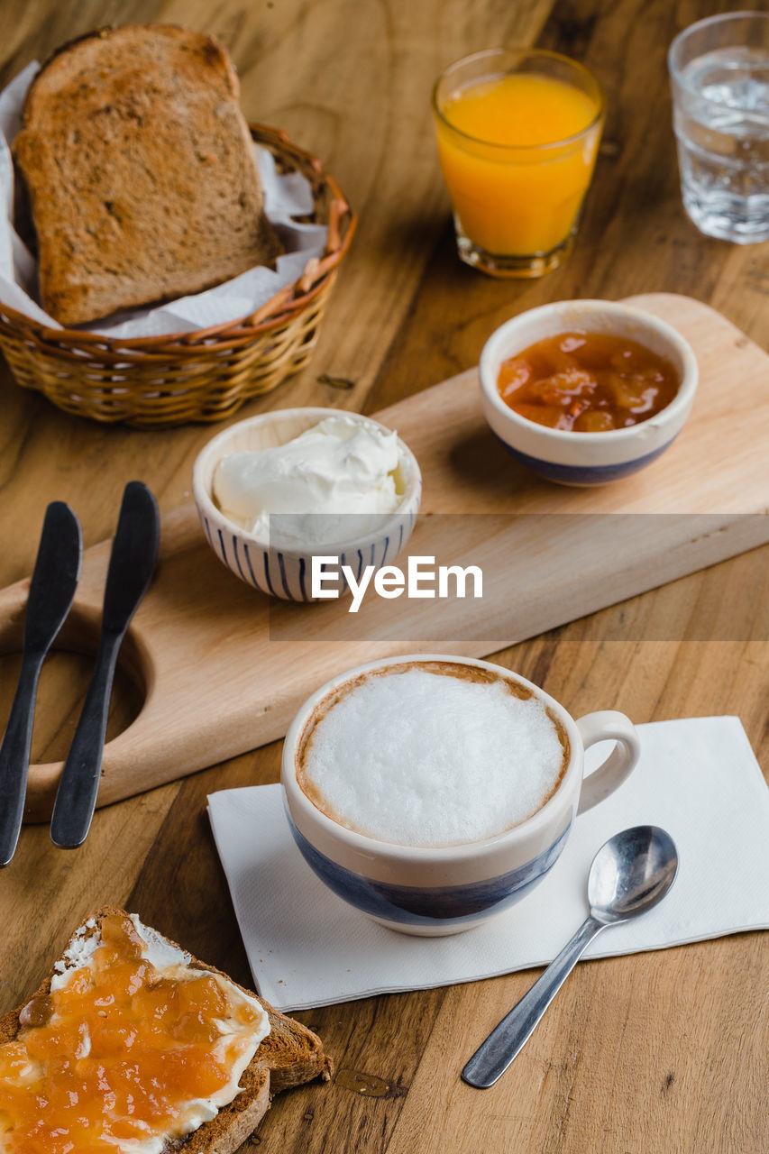 HIGH ANGLE VIEW OF BREAKFAST ON TABLE AT KITCHEN