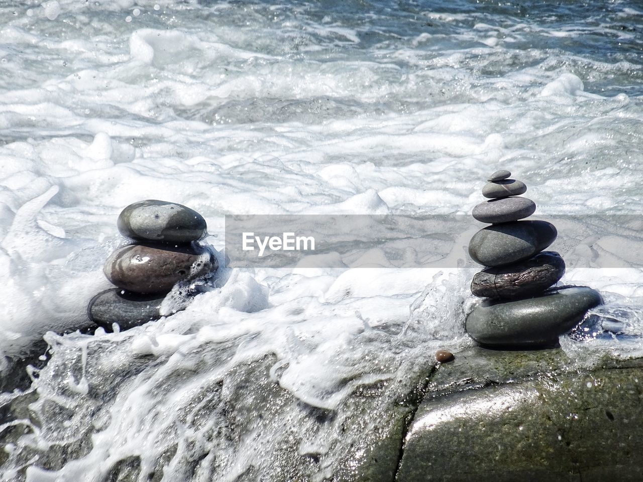 Stack of stones in sea during summer