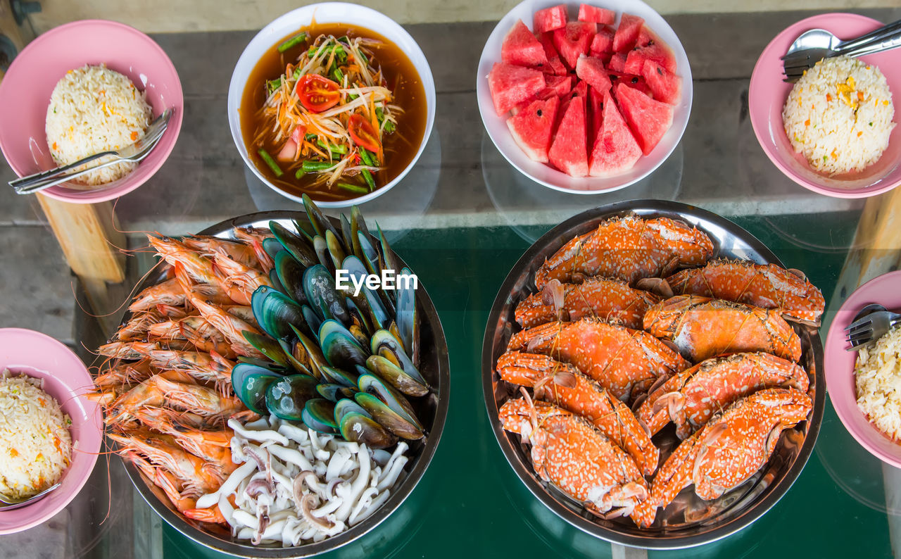 HIGH ANGLE VIEW OF VARIOUS FOOD IN CONTAINER ON TABLE