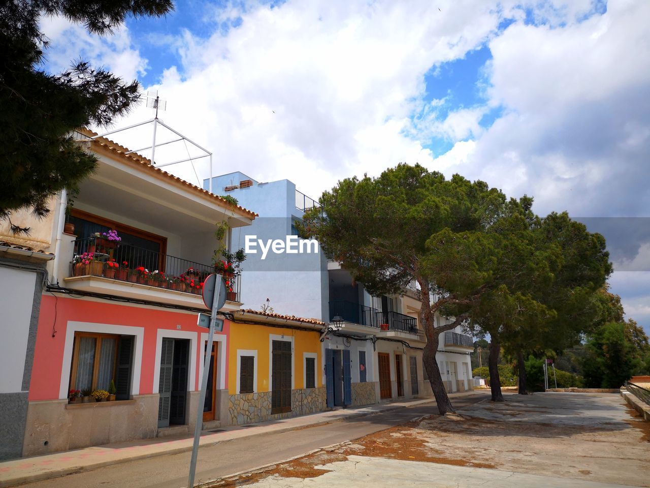 RESIDENTIAL BUILDINGS BY STREET AGAINST SKY