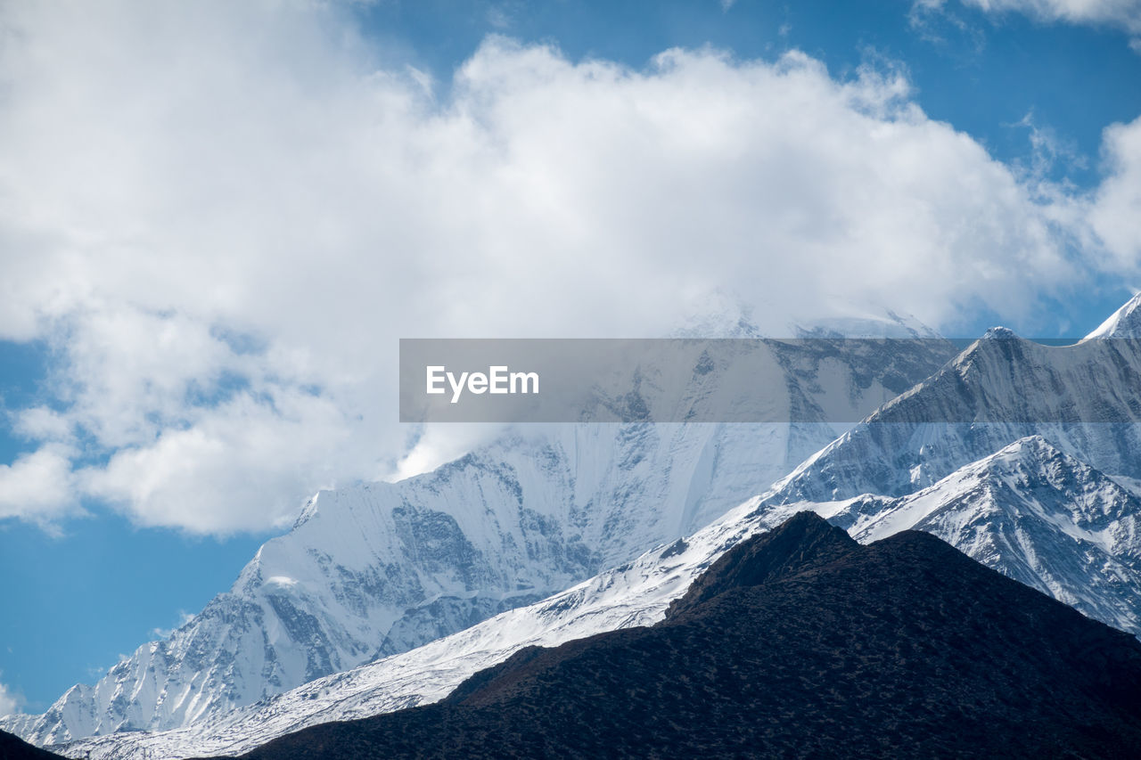 Scenic view of snowcapped mountains against sky