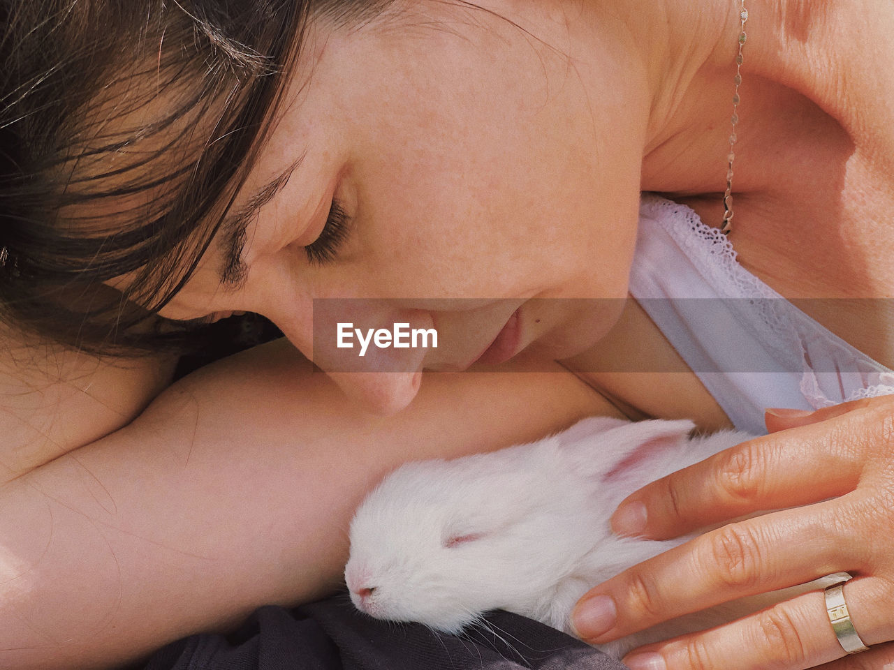 Close-up of woman holding white rabbit