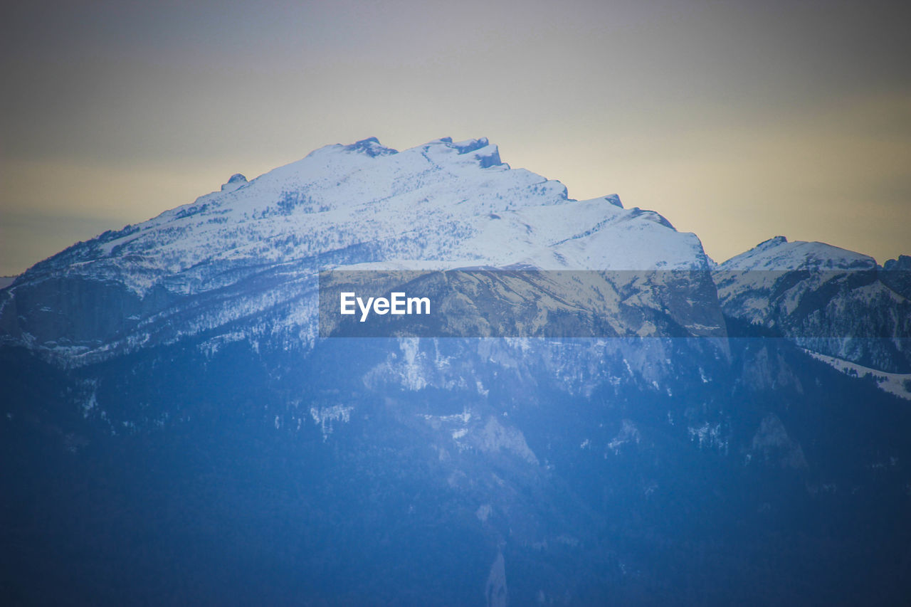 SNOW COVERED MOUNTAIN AGAINST SKY