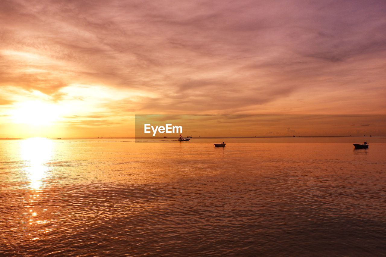 Scenic view of sea against orange sky