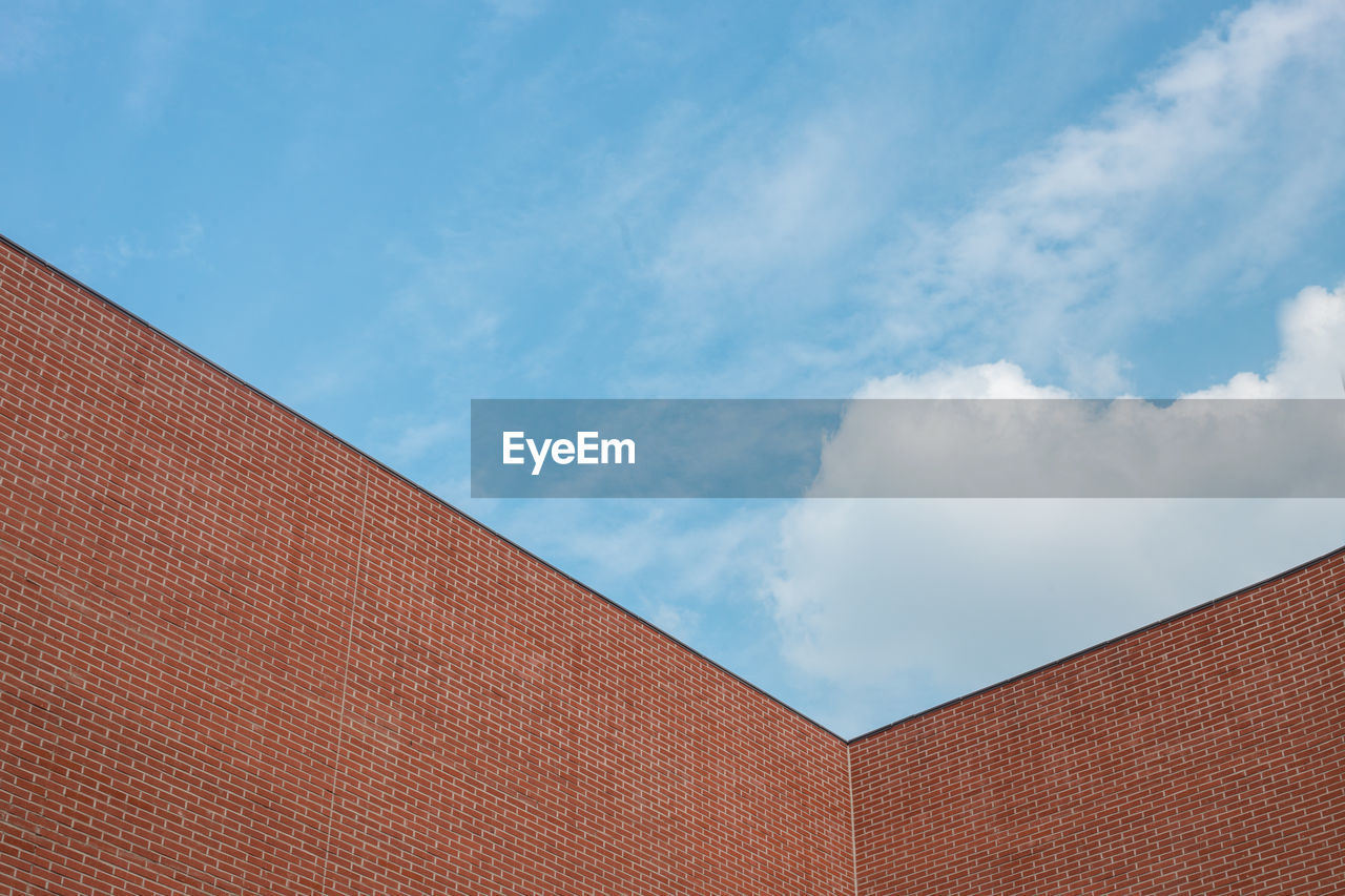 Low angle view of building against cloudy sky