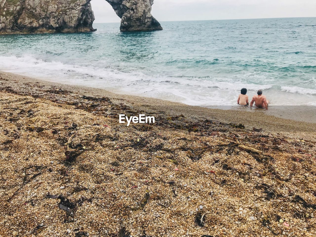 Father and son relaxing in sea