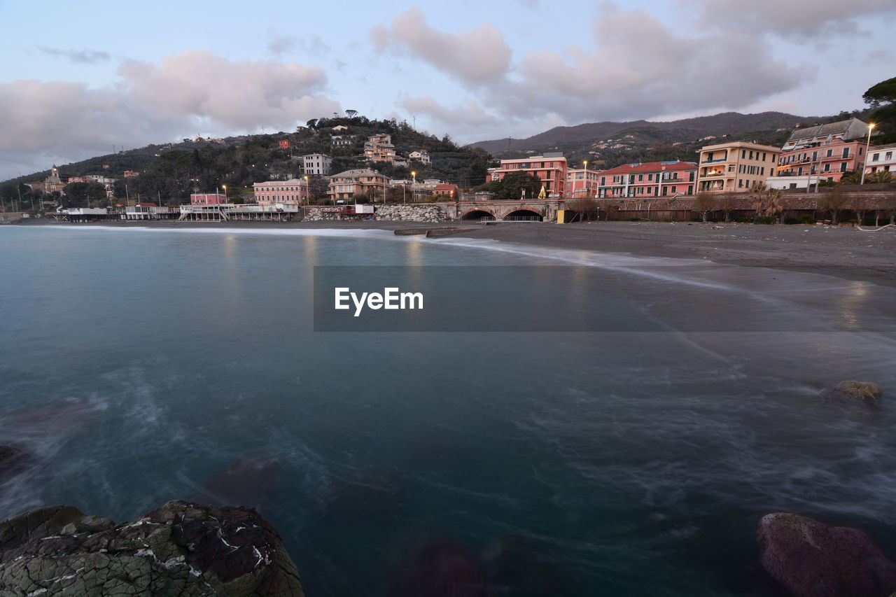 Scenic view of sea and buildings against sky