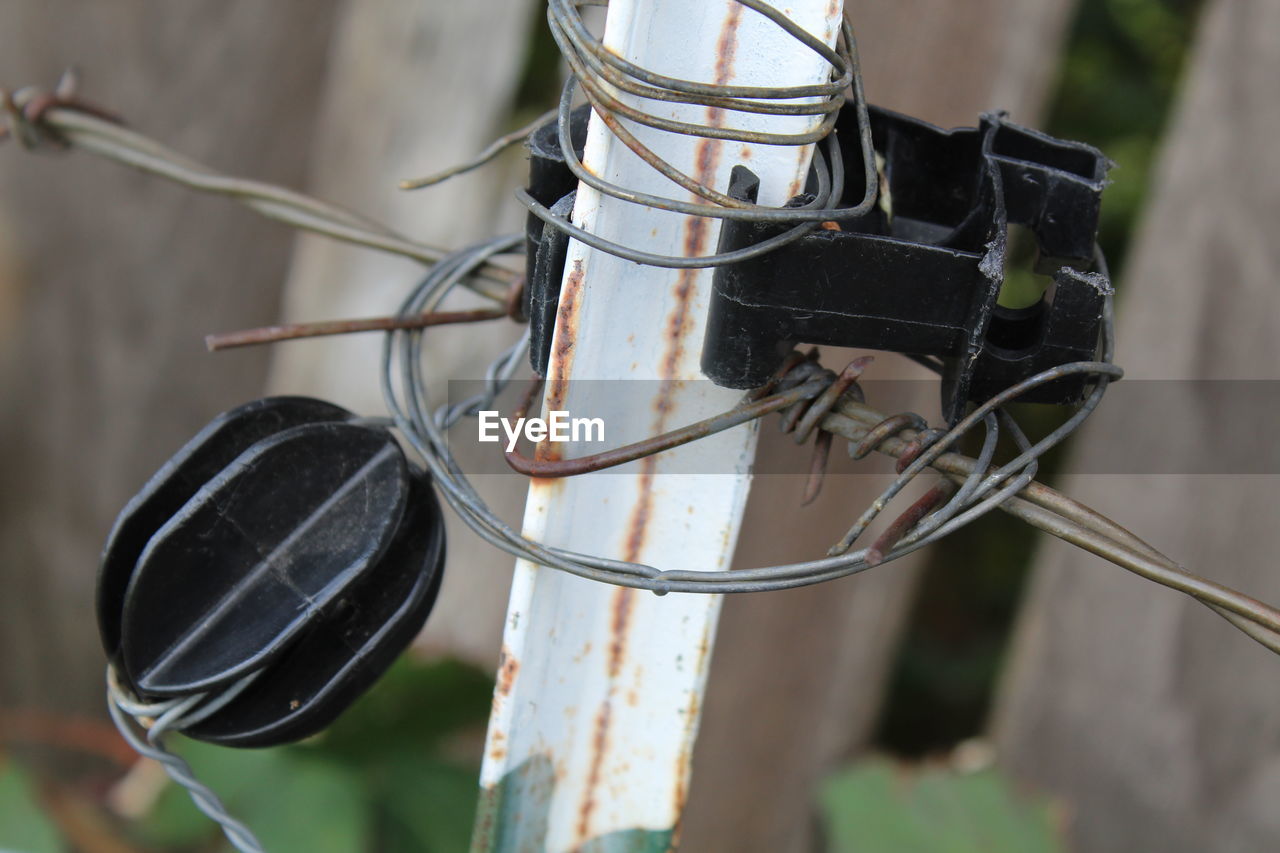 CLOSE-UP OF ELECTRIC LAMP HANGING FROM METAL