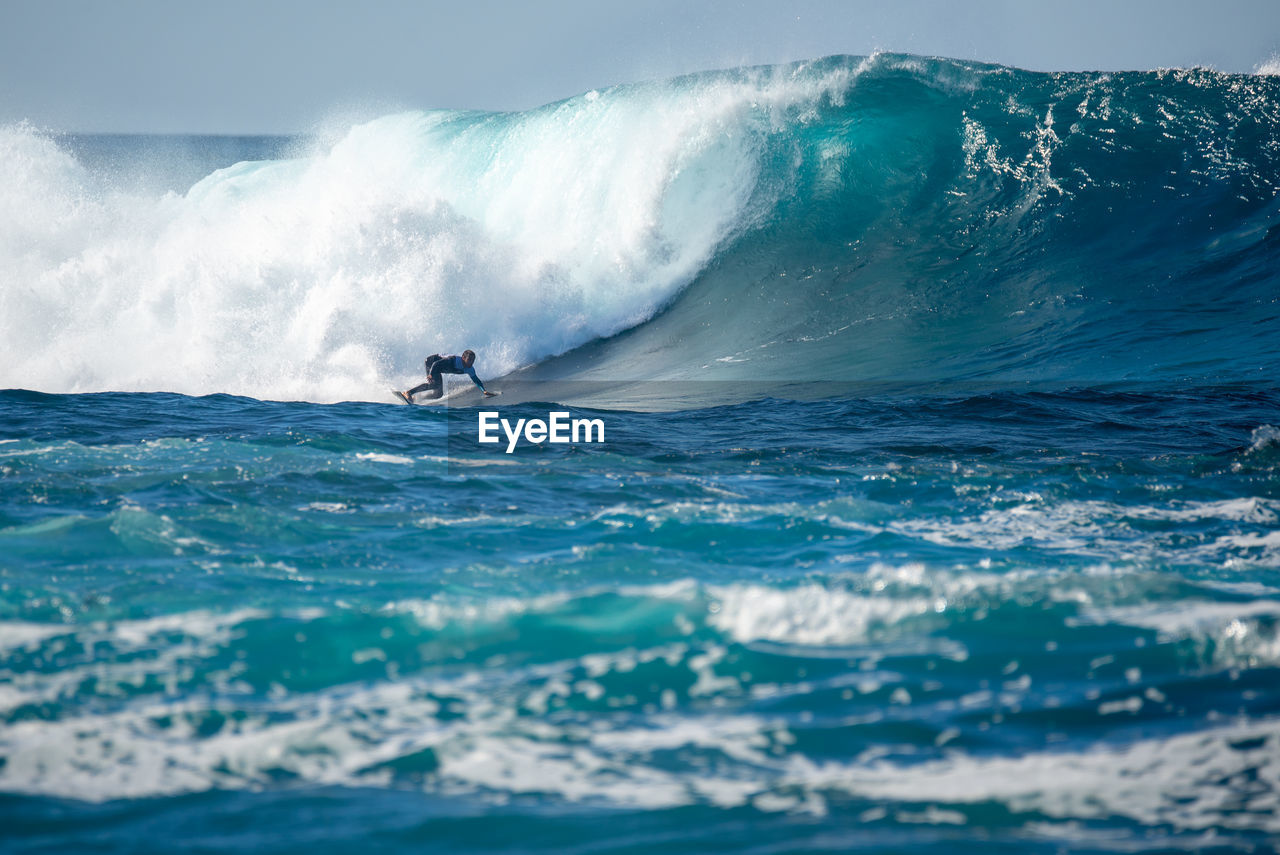 MAN SURFING IN SEA