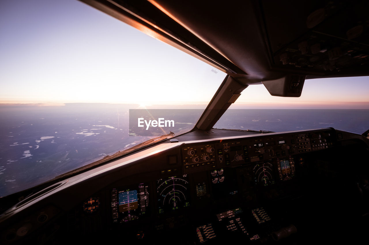 High angle view of airliner cockpit against sky during sunset