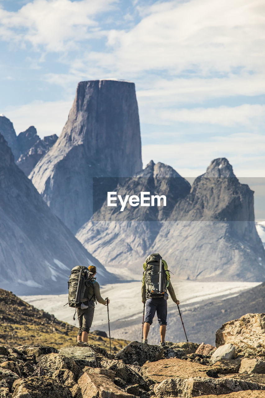 Two climbers enjoy views of mount asgard during their approach.