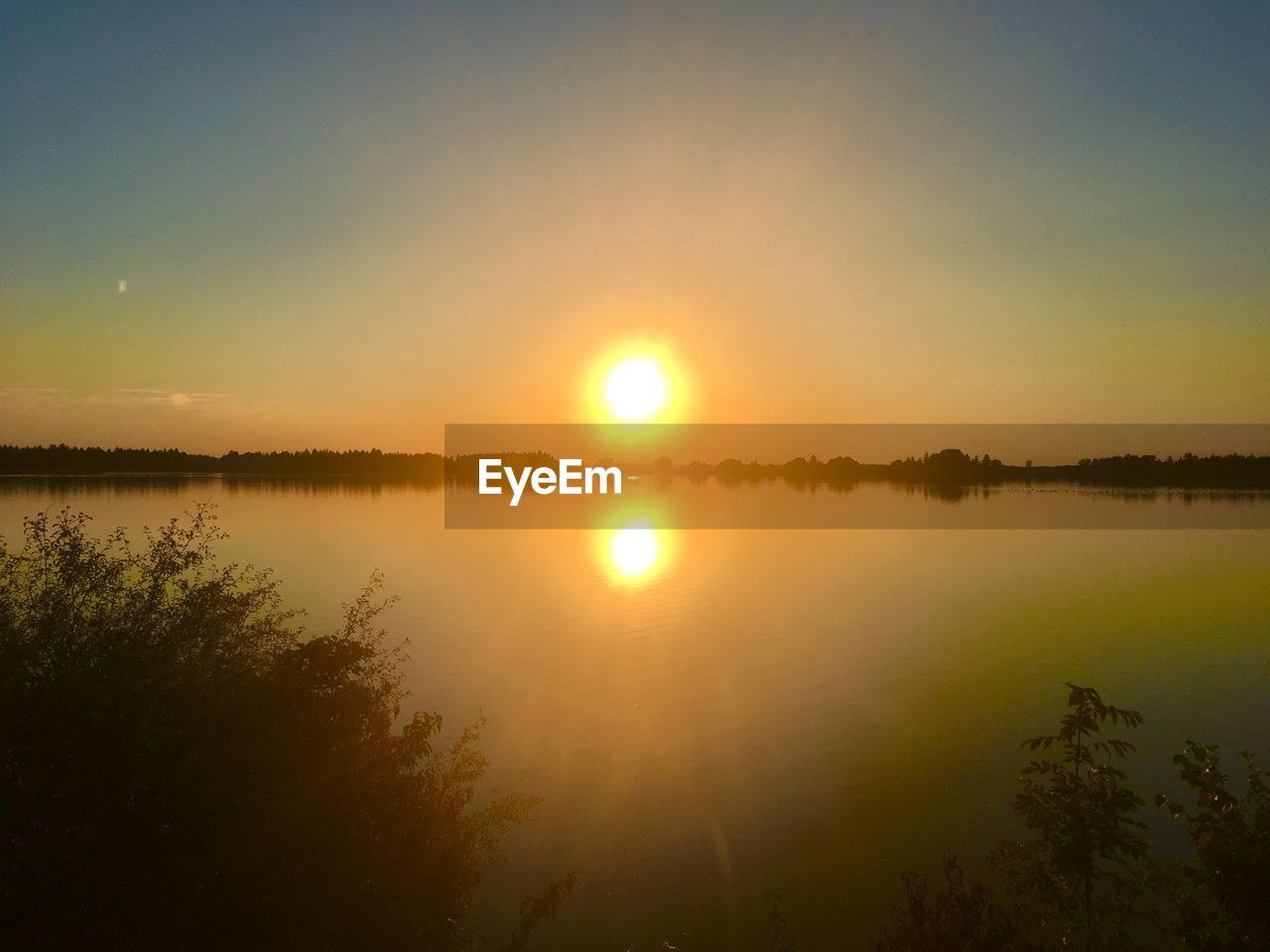 SCENIC VIEW OF LAKE DURING SUNSET