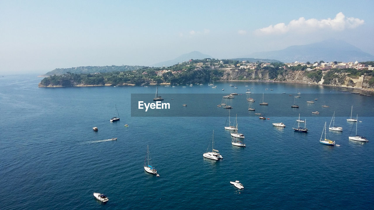 High angle view of sailboats in sea against sky