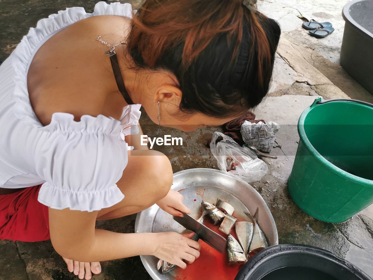 High angle view of woman cutting fish