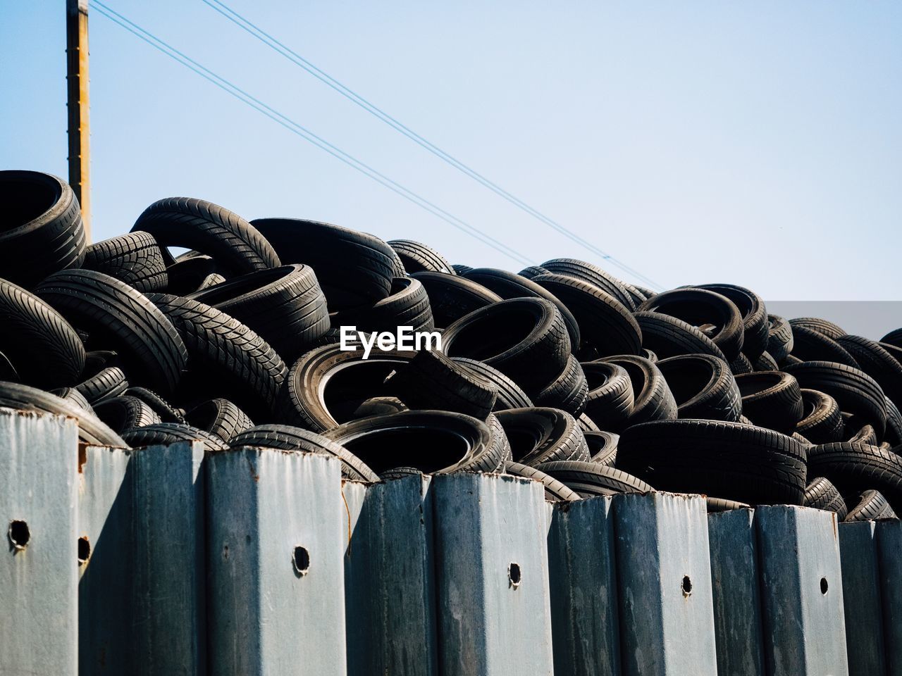 CLOSE-UP OF METAL FENCE AGAINST CLEAR SKY