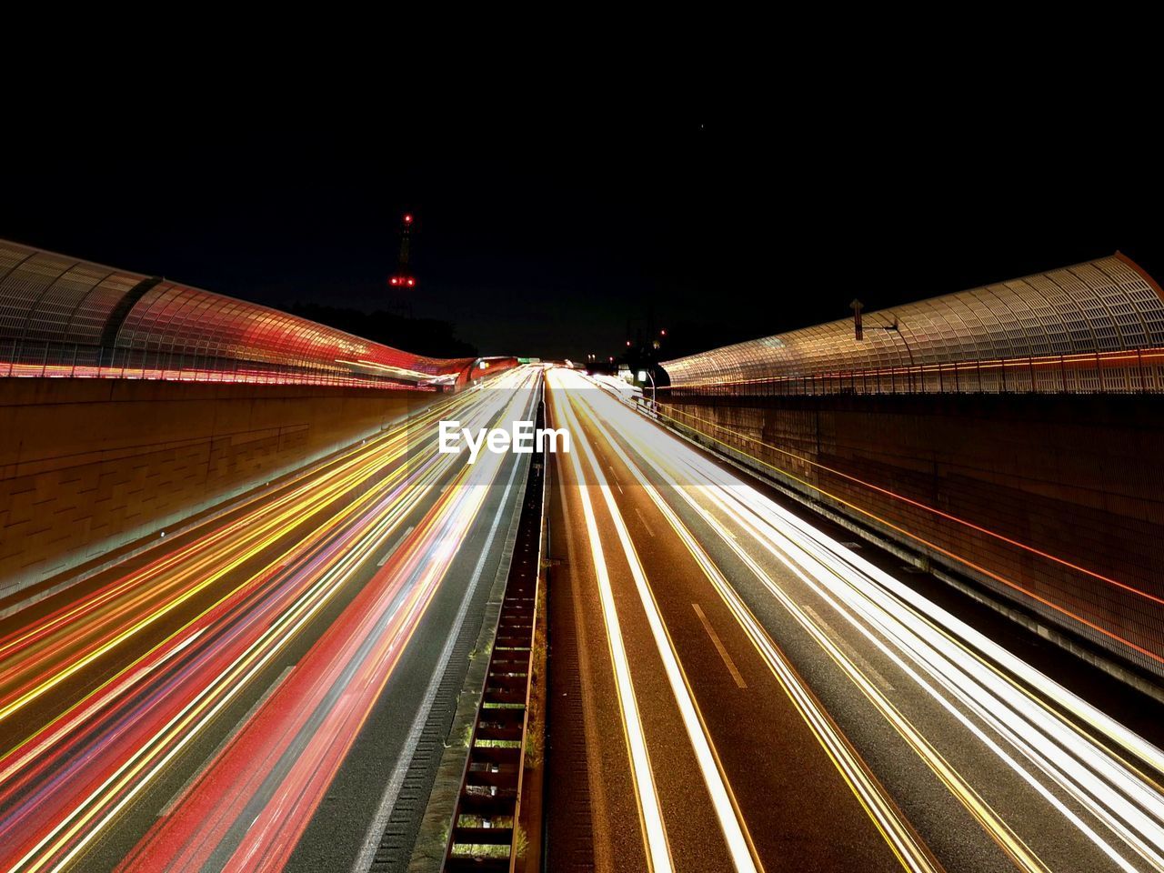 High angle view of light trails on highway at night