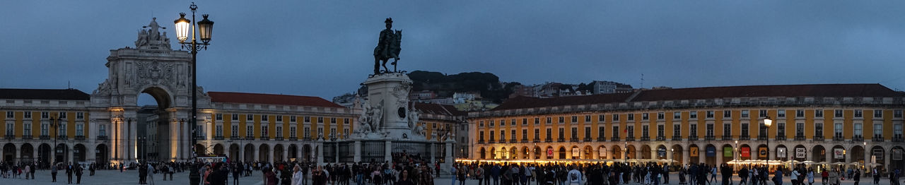 GROUP OF PEOPLE IN FRONT OF BUILDINGS