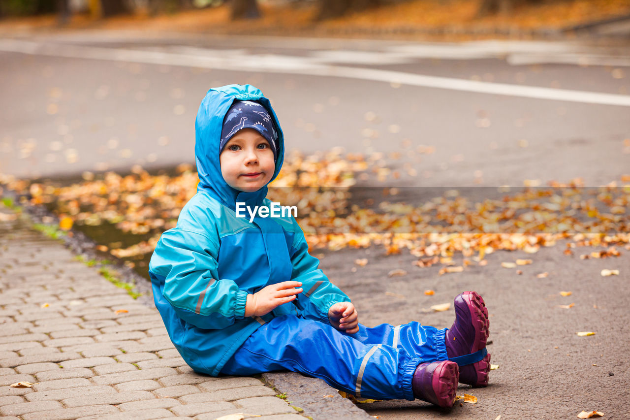 Portrait of boy sitting outdoors