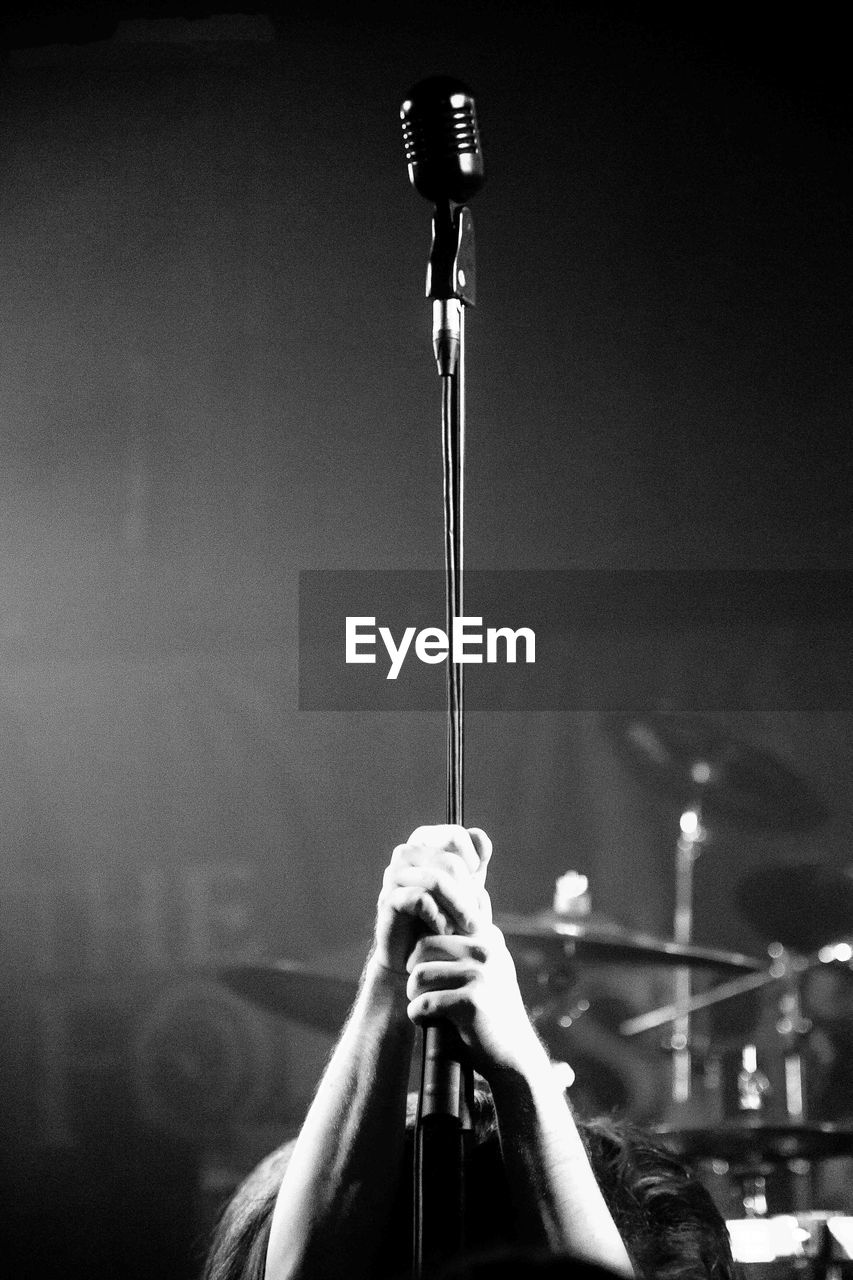 Low angle view of man holding microphone