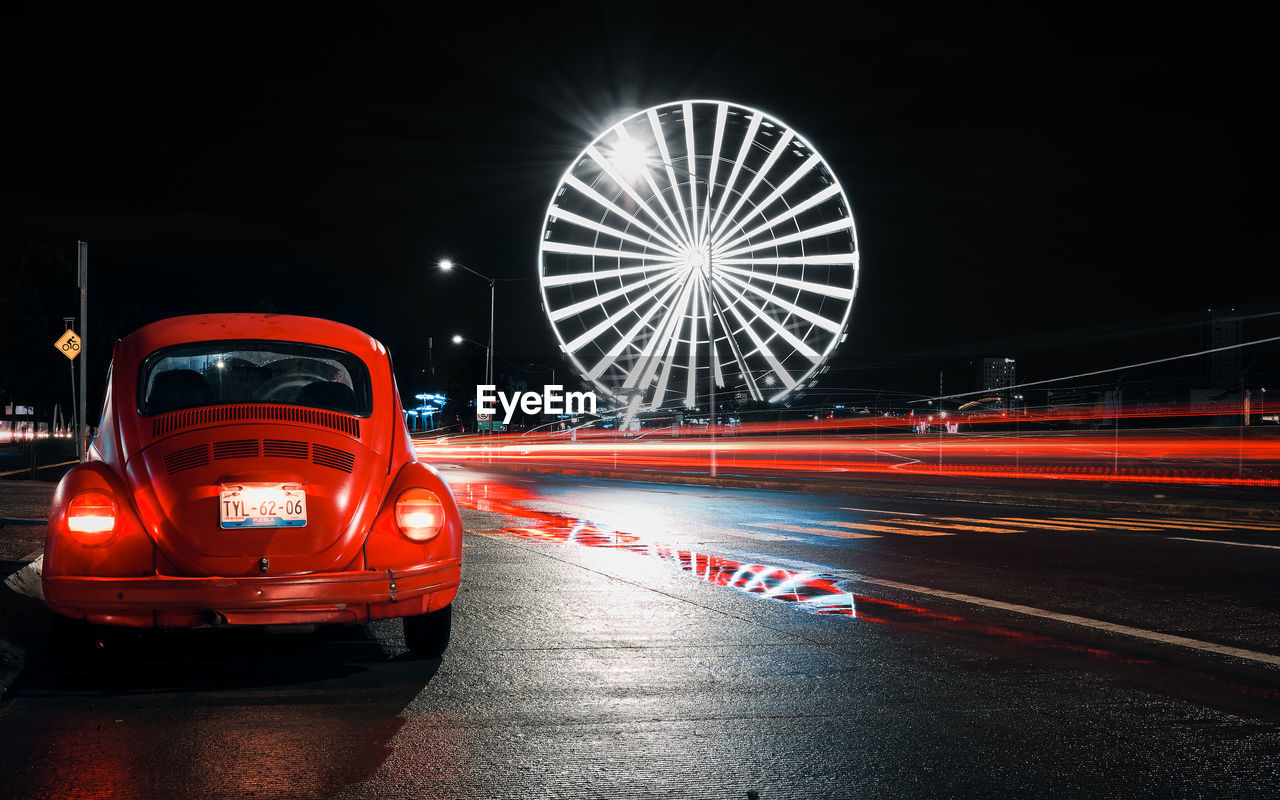 RED LIGHT TRAILS ON STREET AT NIGHT