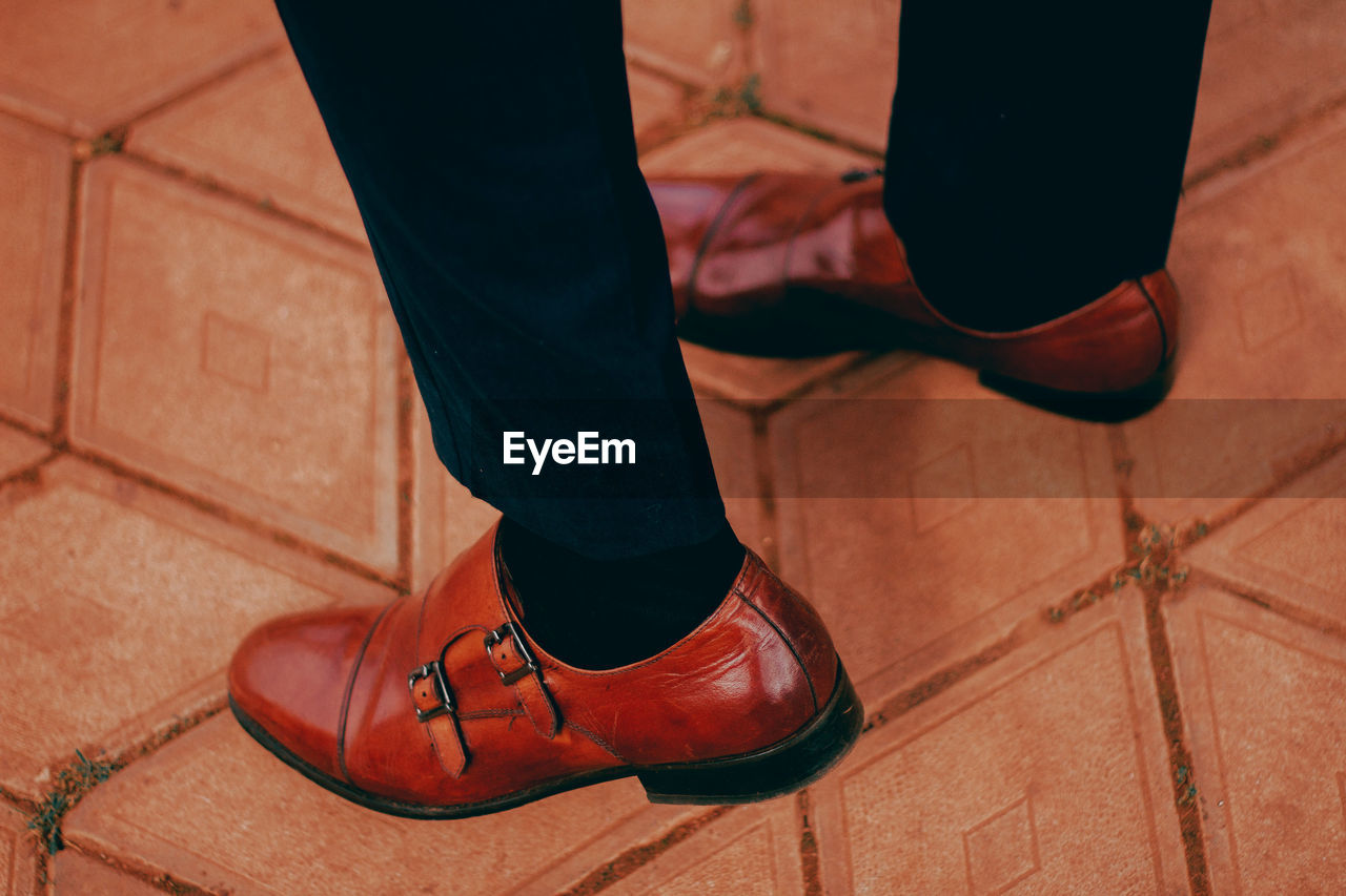 Low section of man walking on floor