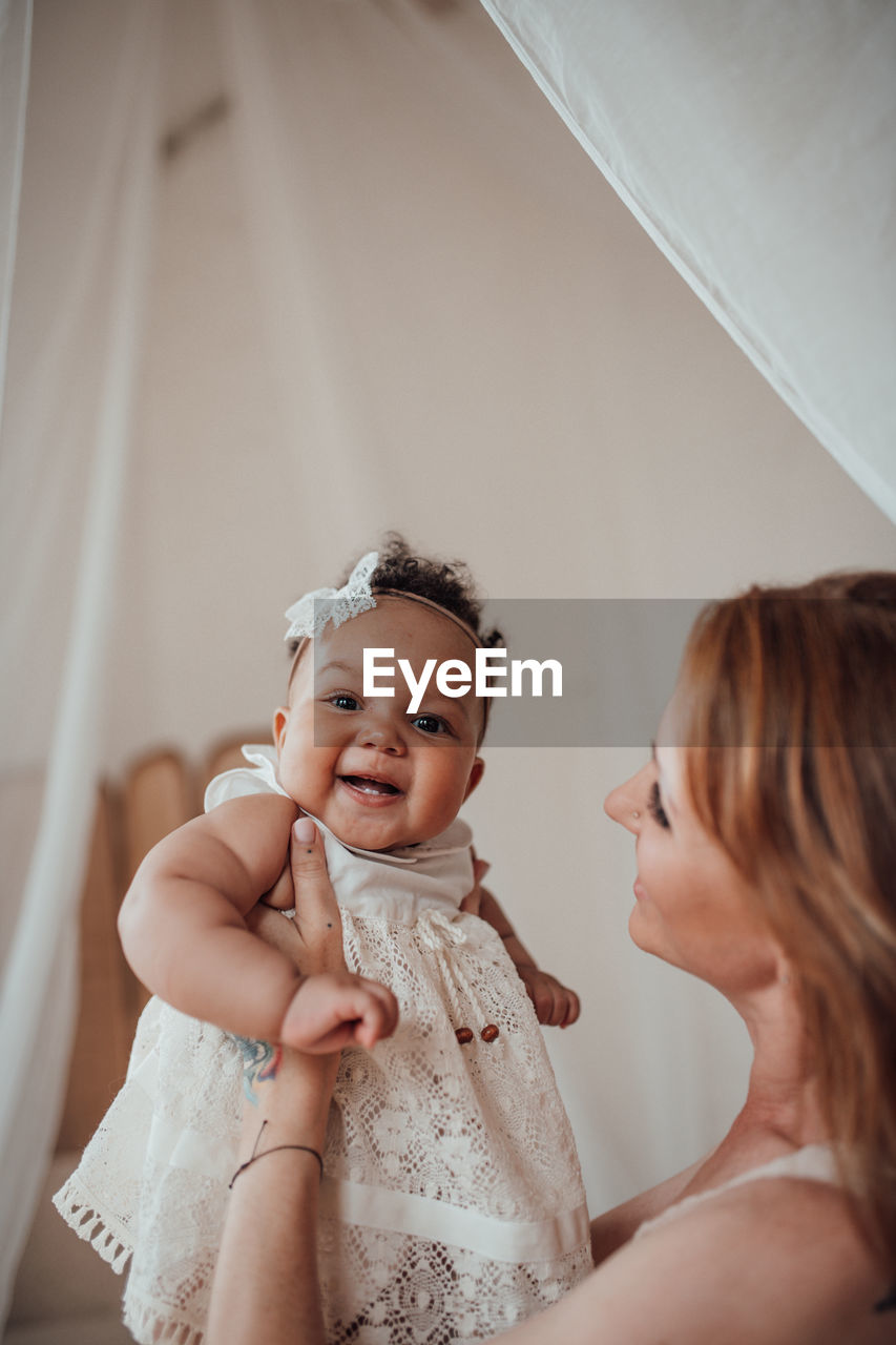 PORTRAIT OF MOTHER AND GIRL WITH HANDS