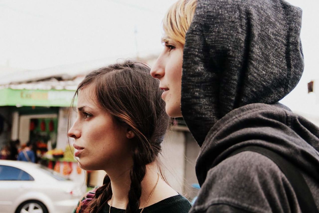 Close-up of two beautiful women in city