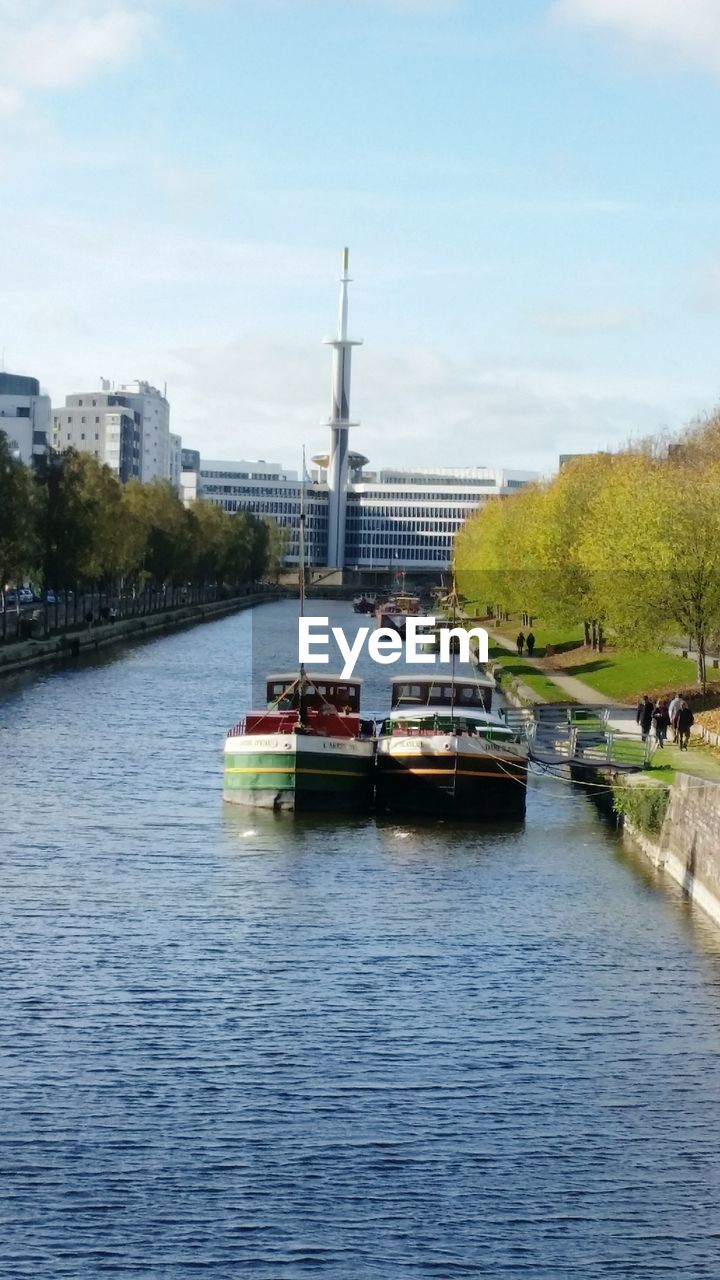 VIEW OF RIVER WITH BUILDINGS IN BACKGROUND