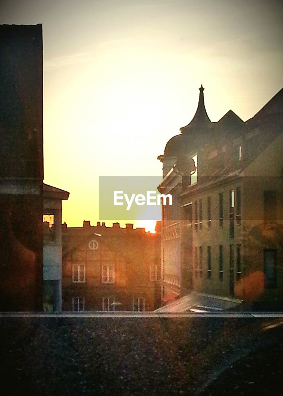 BUILDINGS IN CITY AT SUNSET