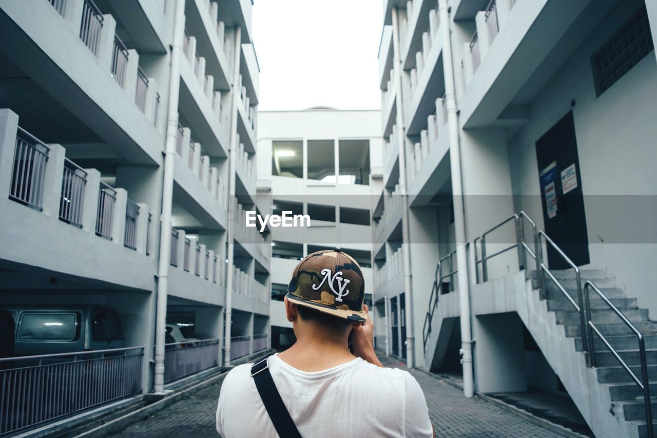 WOMAN STANDING IN FRONT OF BUILDINGS