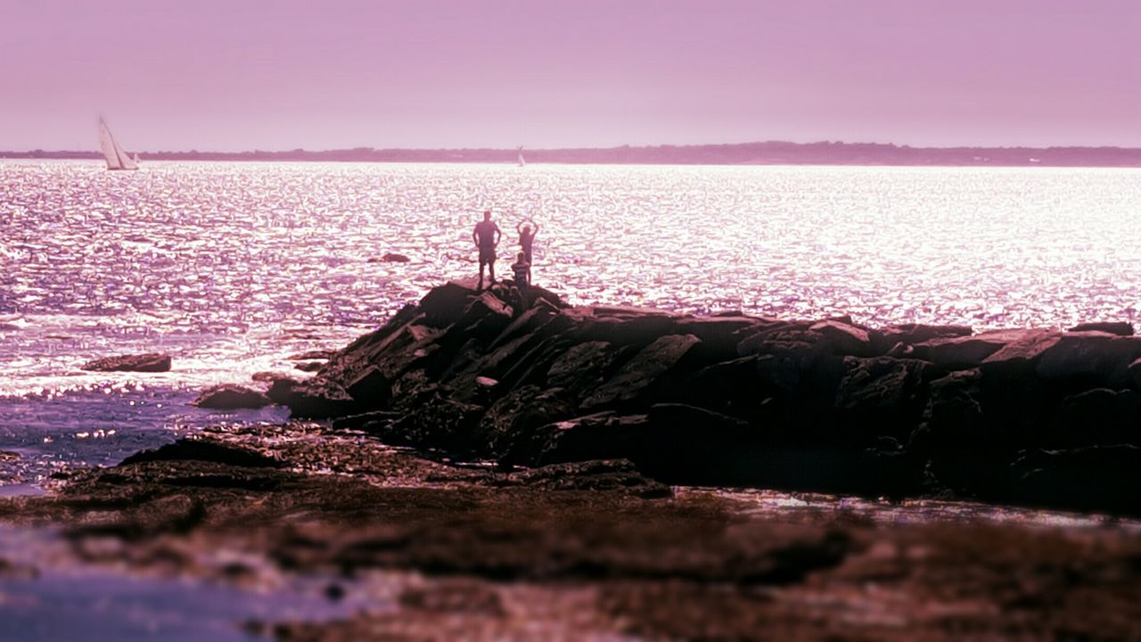 Scenic view of sea against clear sky at sunset