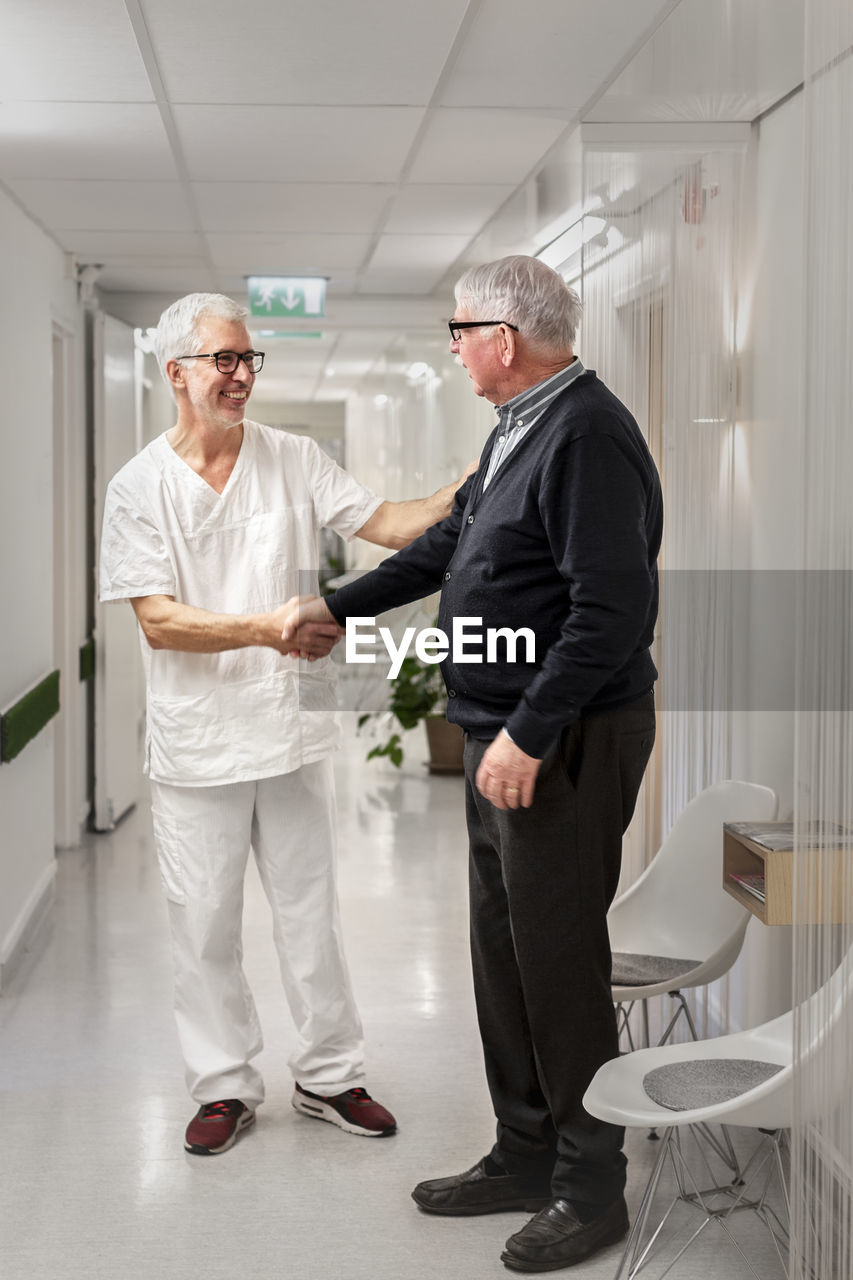 Doctor giving patient handshake