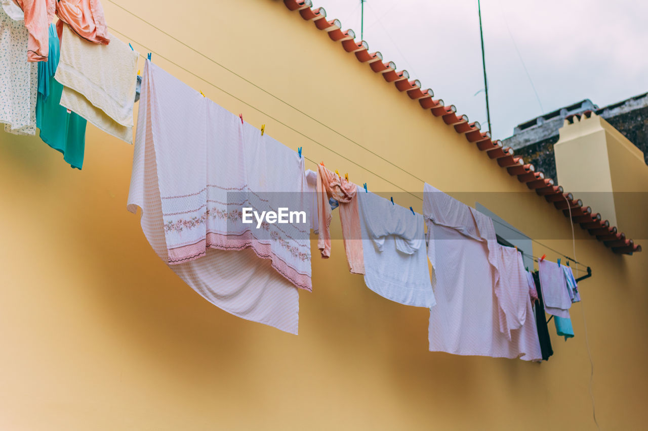 LOW ANGLE VIEW OF CLOTHES DRYING ON CLOTHESLINE