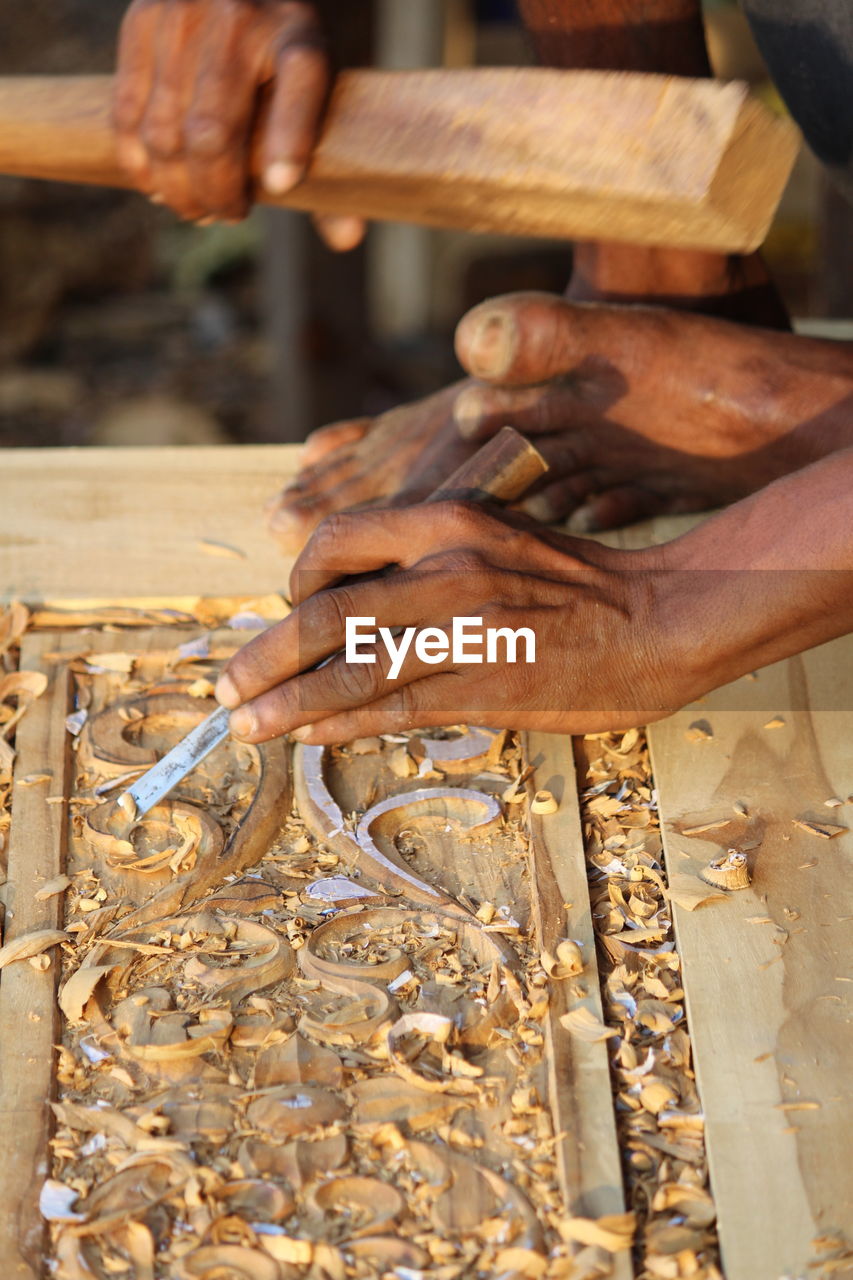 Cropped hand of person working in workshop