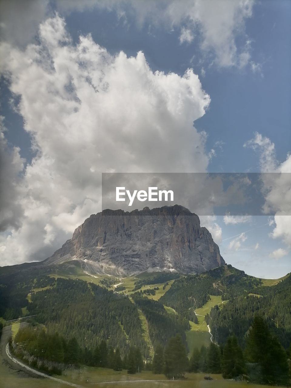 scenic view of mountains against cloudy sky