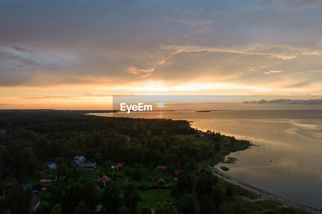 sky, water, sunset, sea, cloud, horizon, beauty in nature, coast, environment, land, nature, scenics - nature, landscape, beach, dusk, plant, shore, evening, tranquility, horizon over water, travel destinations, no people, travel, sun, ocean, outdoors, architecture, sunlight, tranquil scene, reflection, tourism, dramatic sky, tree, coastline, summer, city, body of water, seascape, hill, trip, building, vacation, idyllic, cloudscape, blue, holiday, twilight, built structure, orange color, afterglow, building exterior, grass, urban skyline