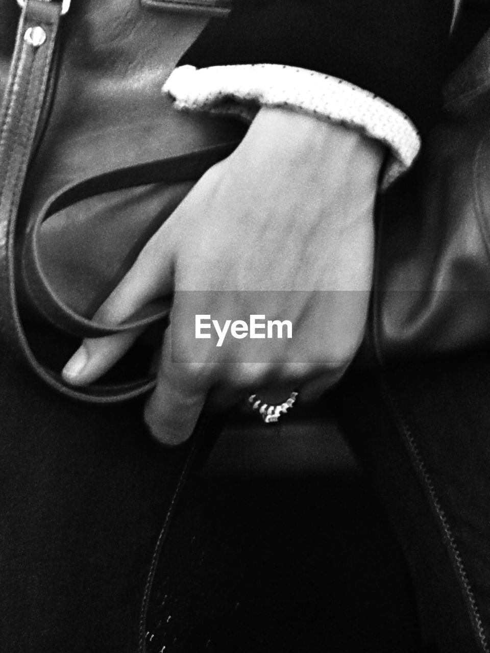 Close up image of a woman holding a purse