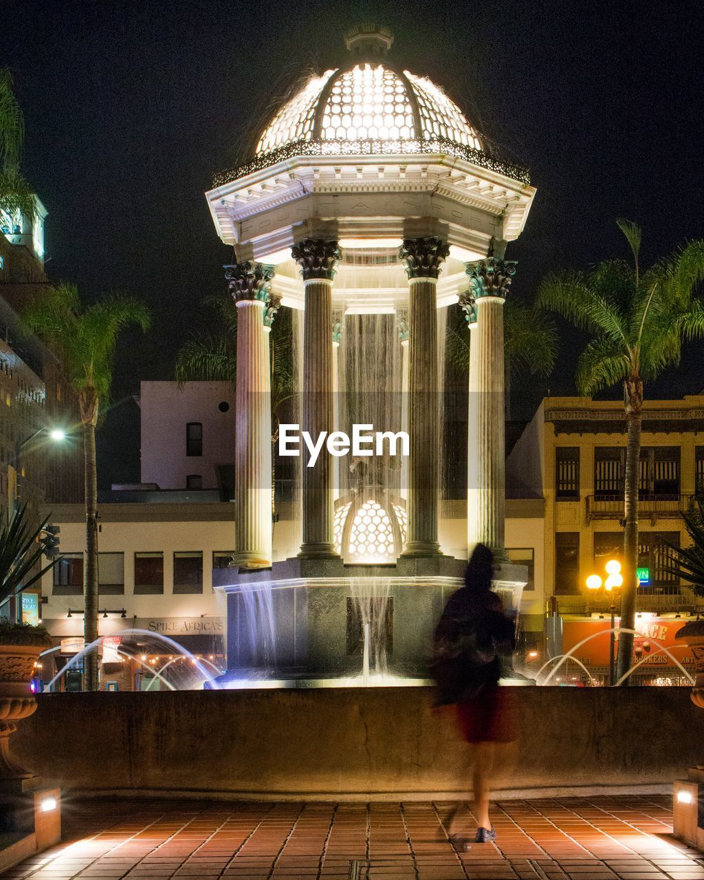 MAN IN ILLUMINATED BUILDING