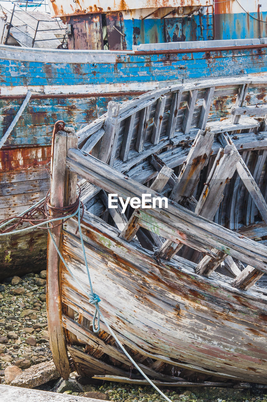 OLD BOAT MOORED AT SHORE