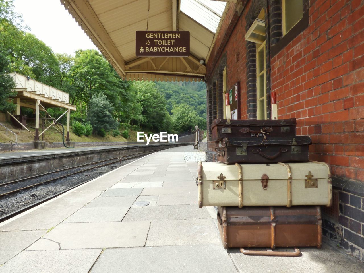 Stacked suitcases at railroad station platform