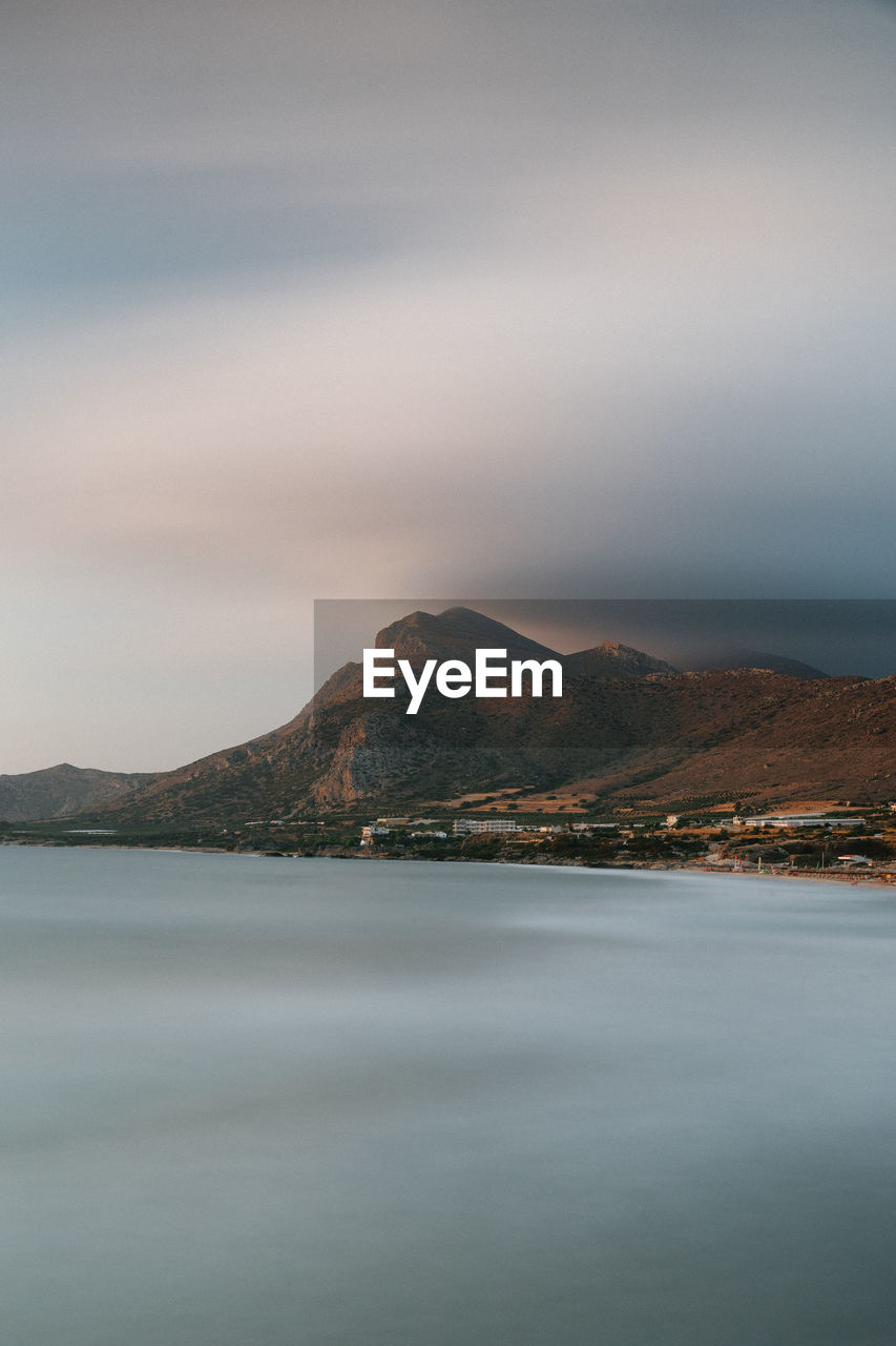 Scenic view of sea against sky long exposire mountain clouds greece crete