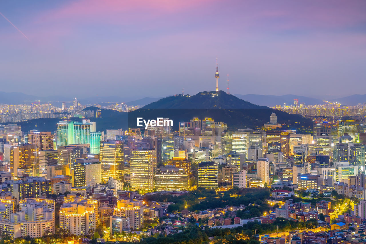 high angle view of illuminated cityscape against sky