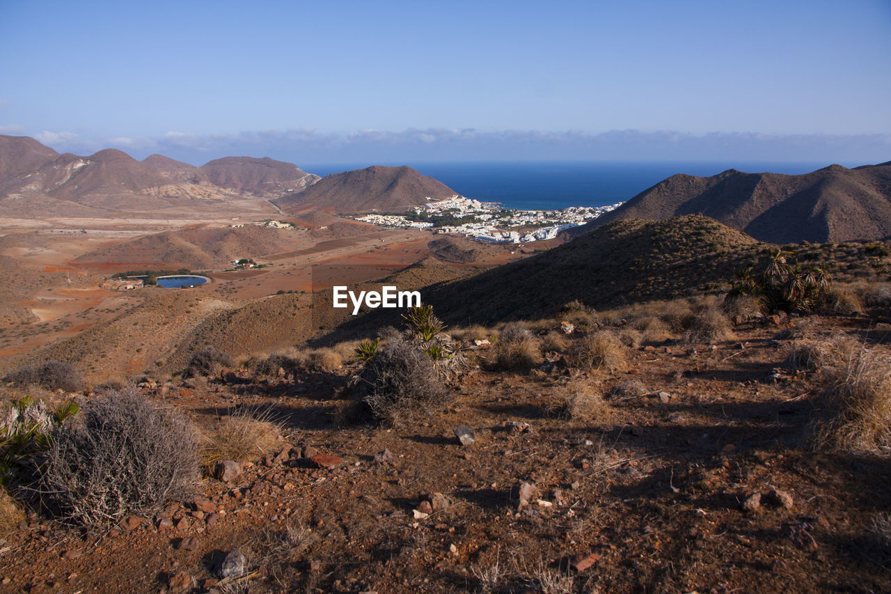 Aerial view of sea and mountains against sky