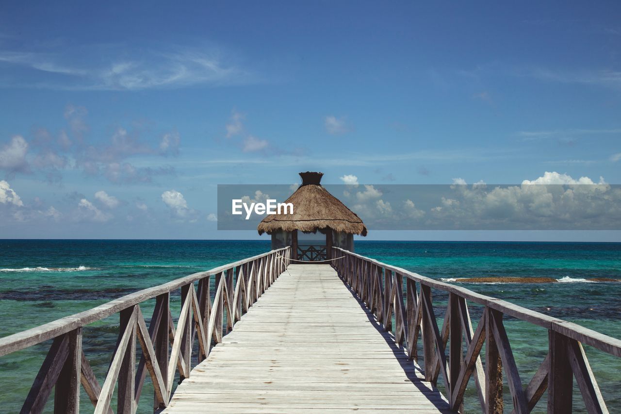 Pier over sea against sky