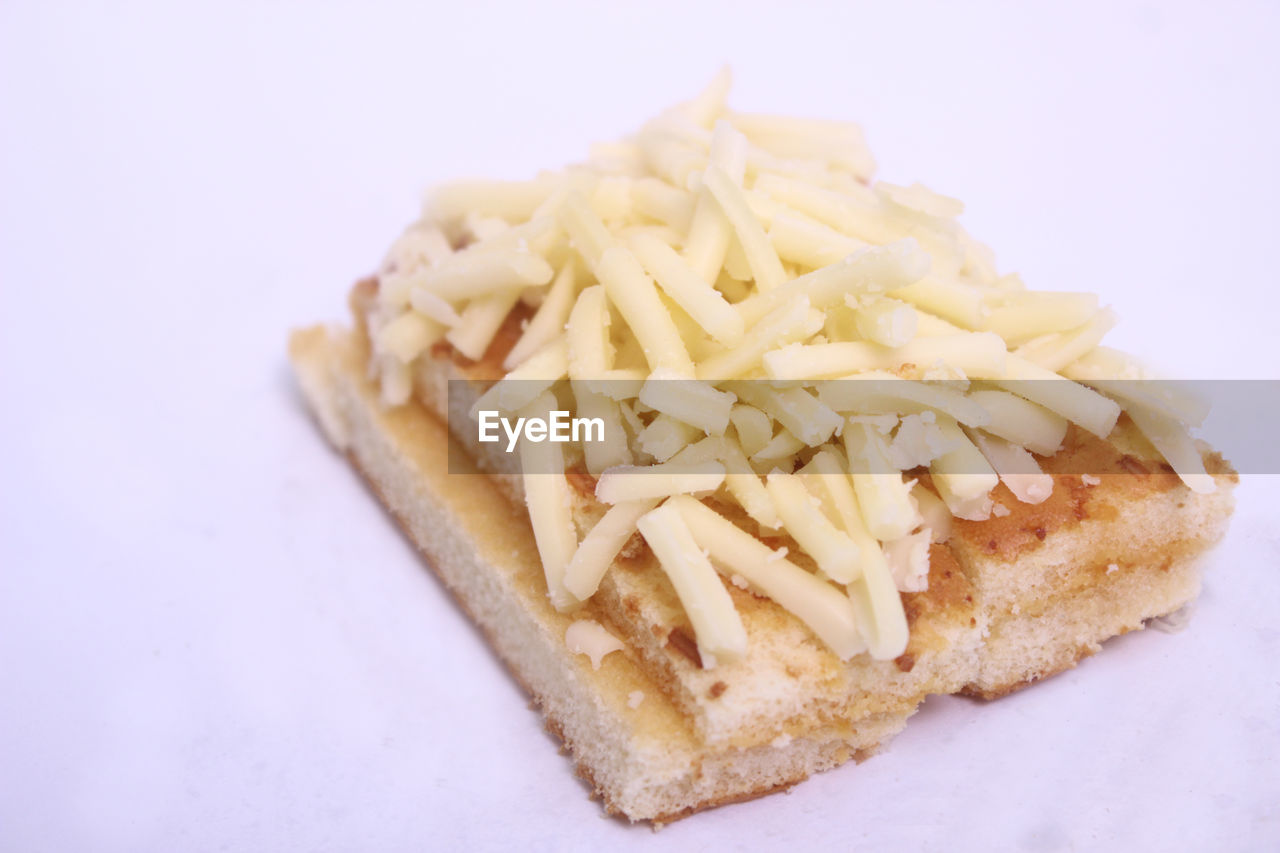 Close-up of shredded cheese on food