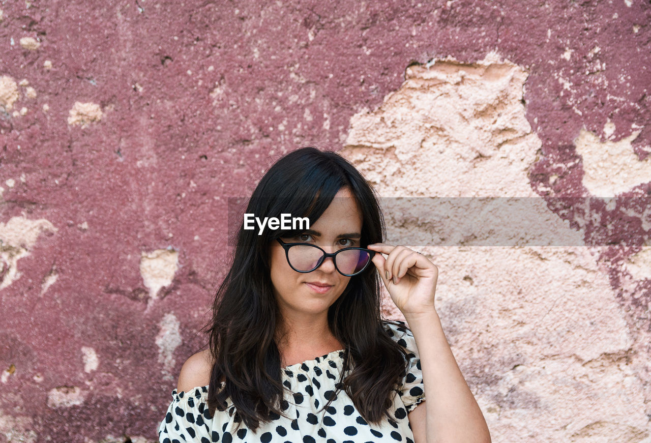 Portrait of a beautiful young woman with eyeglasses, hipster, librarian look, long hair, face.