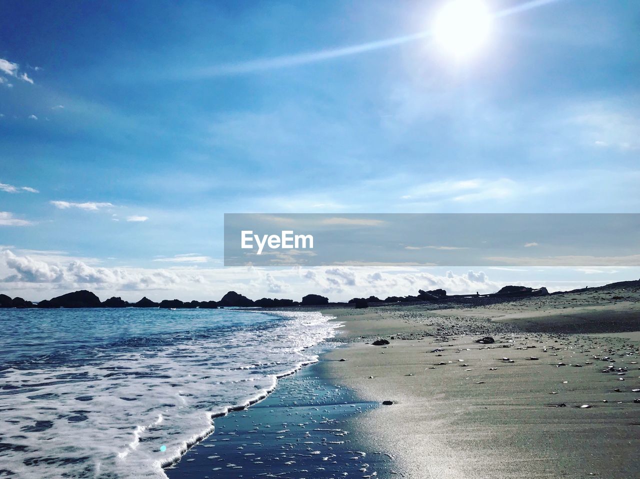 Scenic view of sea against sky on sunny day