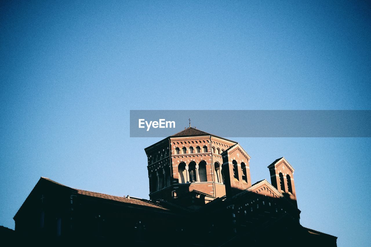 Low angle view of church against clear blue sky