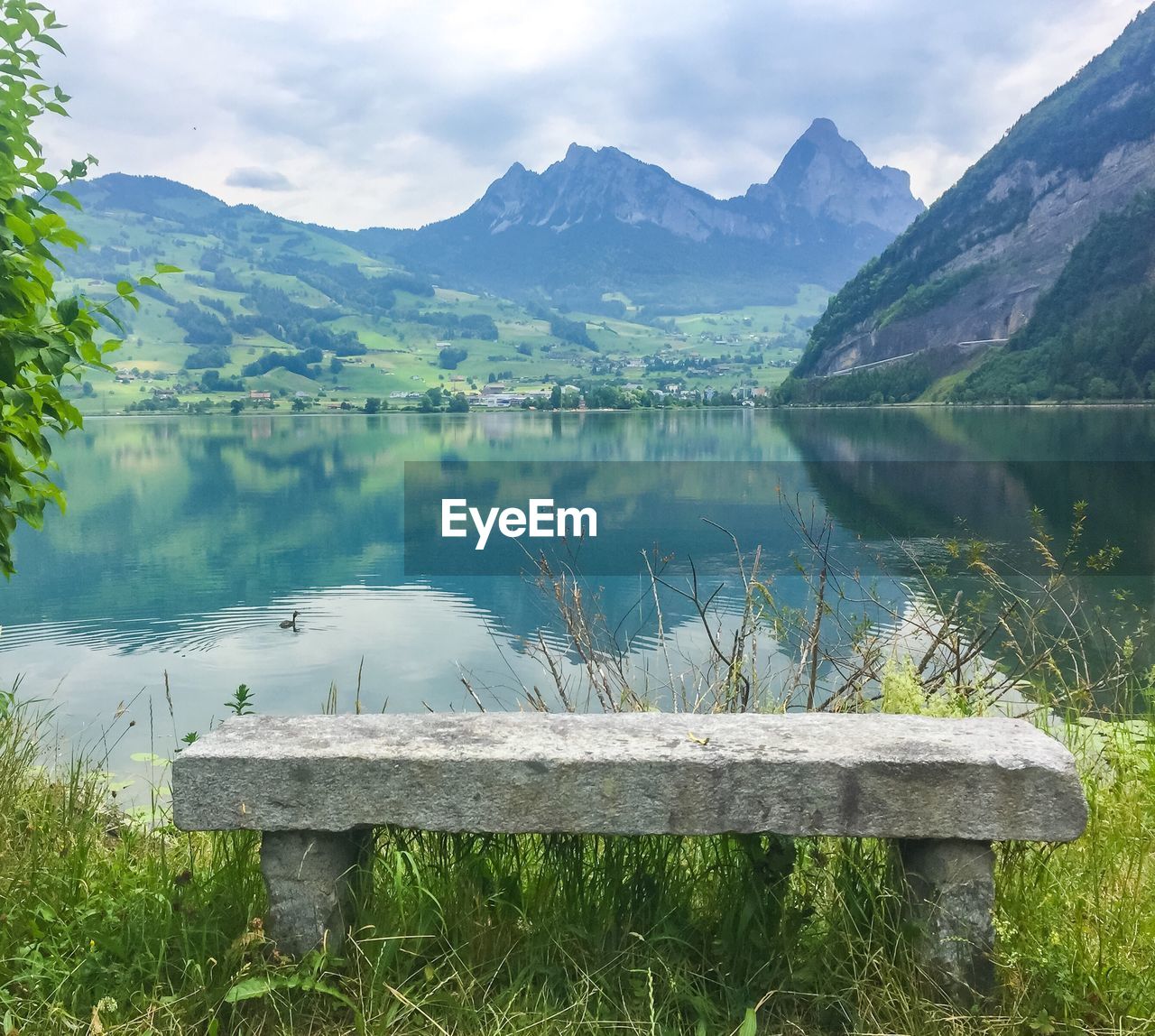 Scenic view of lake and mountains against sky